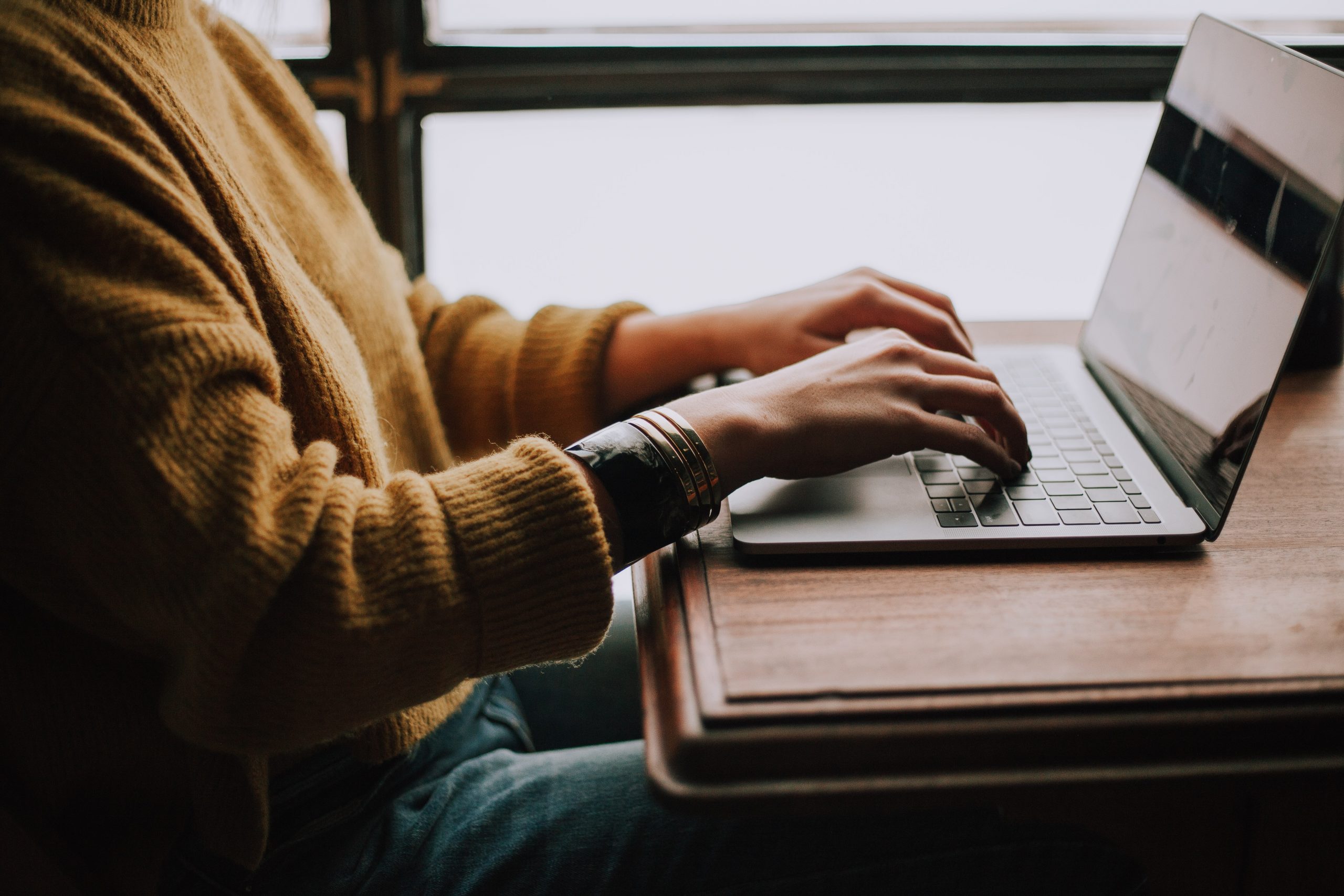 Person typing on their laptop