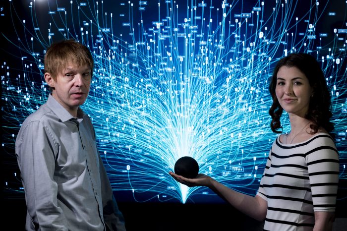 NCBI service users Robbie Ford and Aine Sullivan smiling and holding an Alexa device