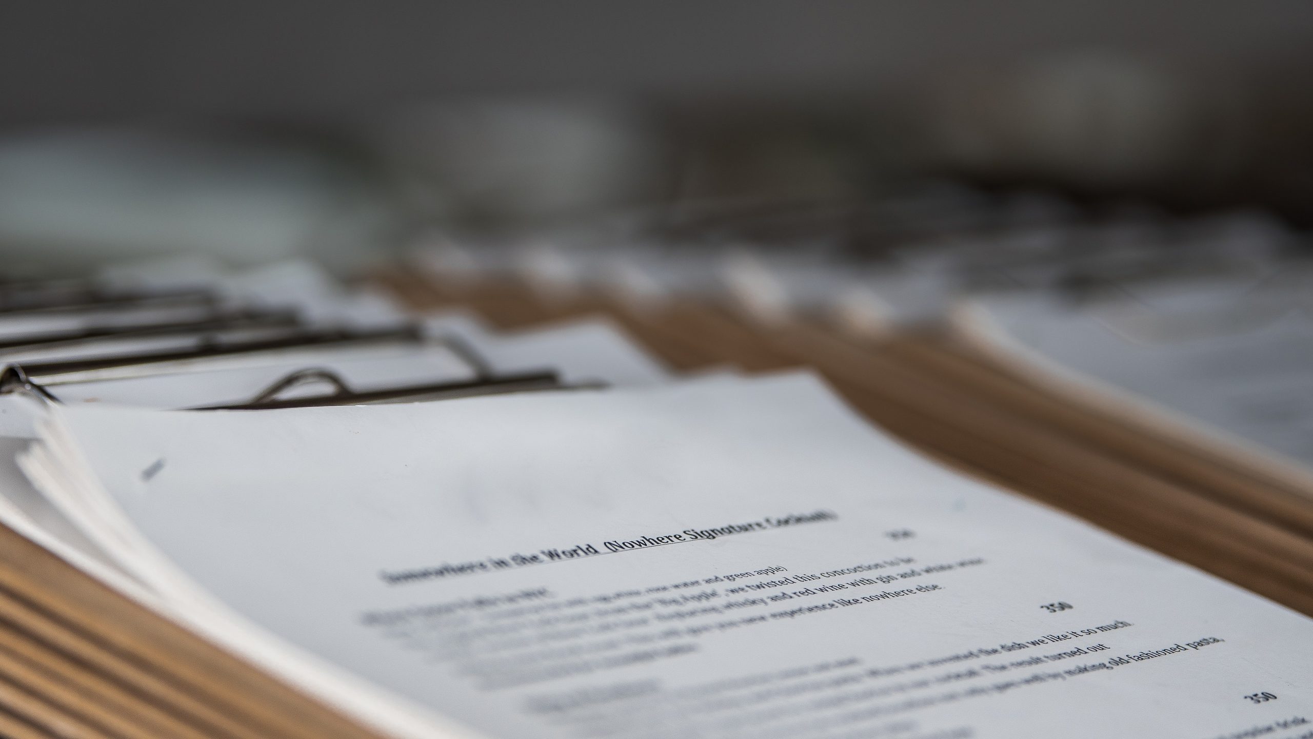 A stack of clipboards with printed documents attached