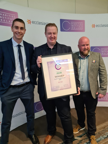 JP Corcoran, Kyran O'Mahoney and Sean Doran holding the Digital Transformation 2022 award for NCBI at the Charity Excellence Awards