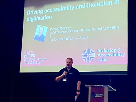 Kyran O'Mahoney speaking on the stage of Business Beyond Borders about driving accessibility and inclusion in digitisation