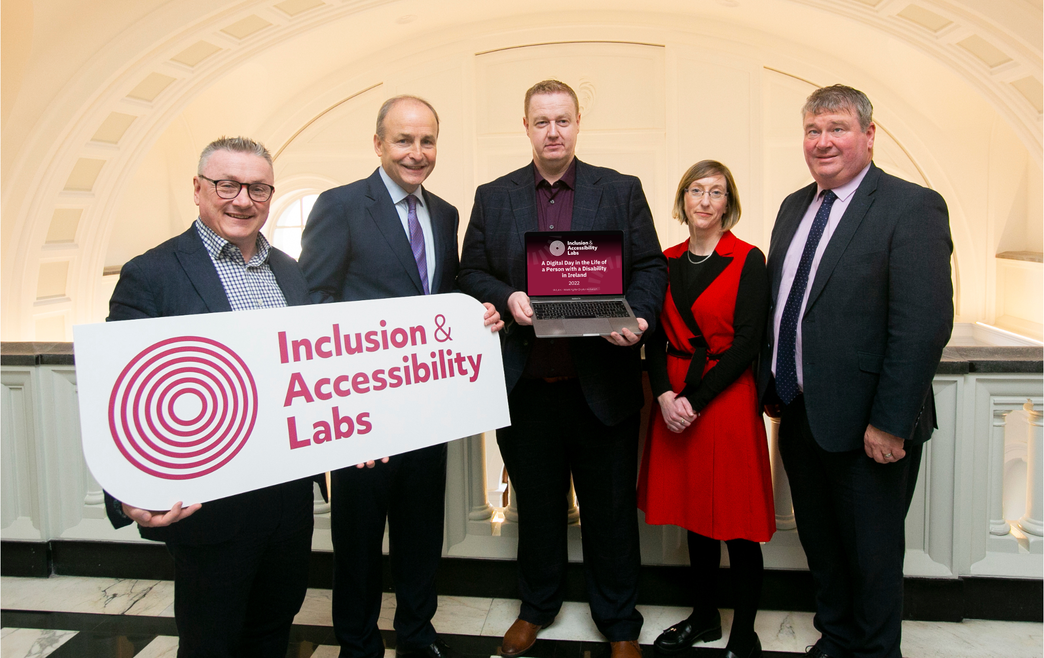 Chris White, Taoiseach Micheál Martin, Kyran O'Mahoney, June Tinsely & Senator Martin Conway holding a laptop with the Digital Day Report