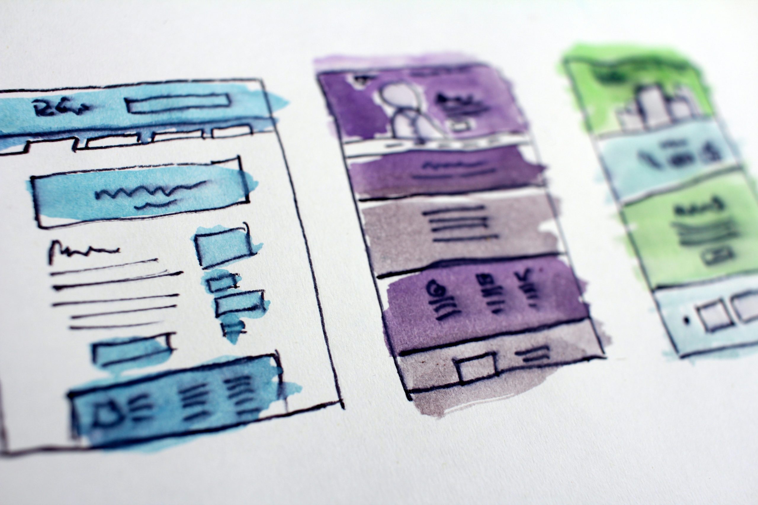 Blue, purple, and green watercolour sketches of a mobile app user interface design