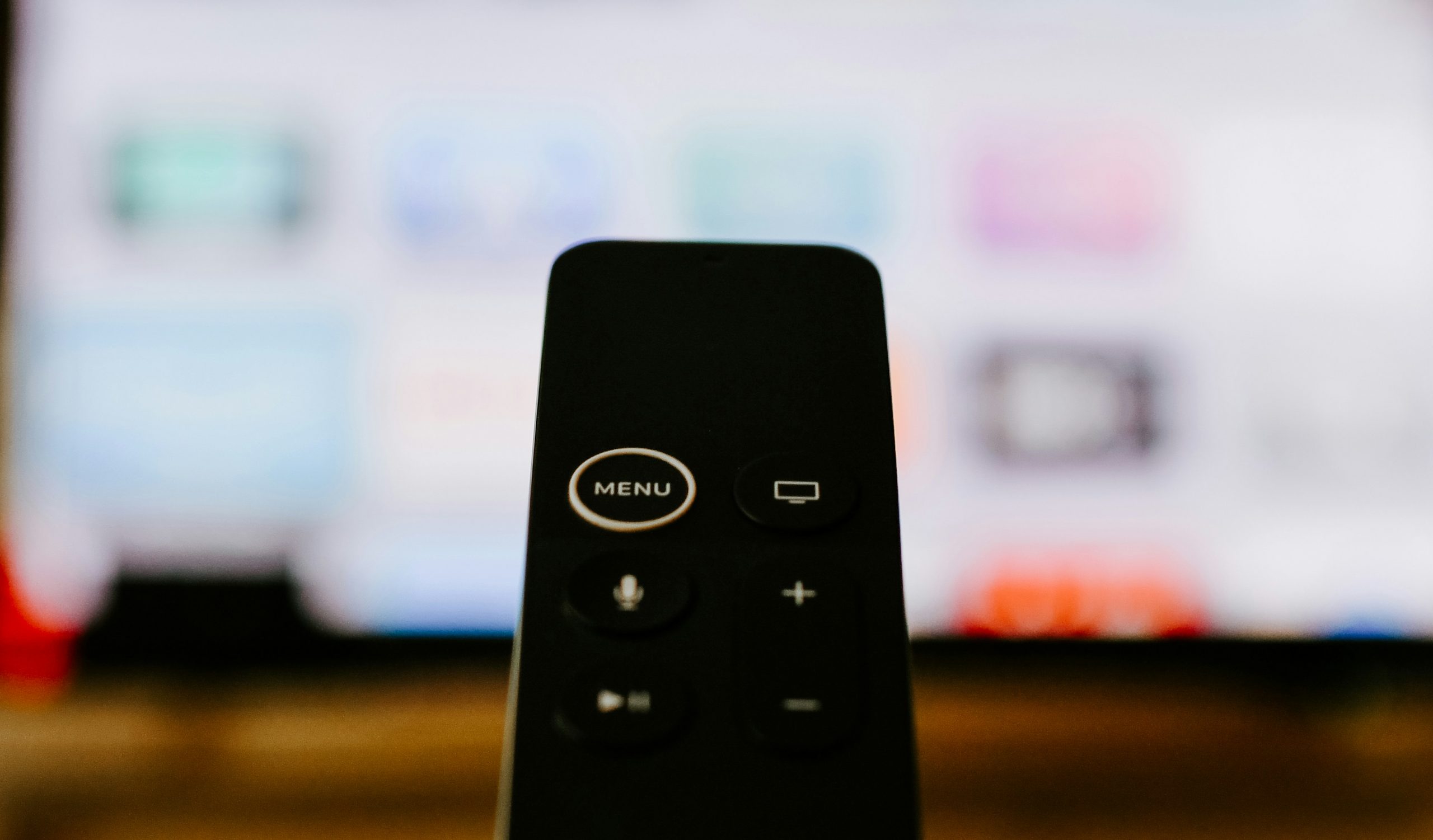 A Smart TV remote, which is an example of a device with concurrent input mechanisms. The TV accepts remote control and voice commands.